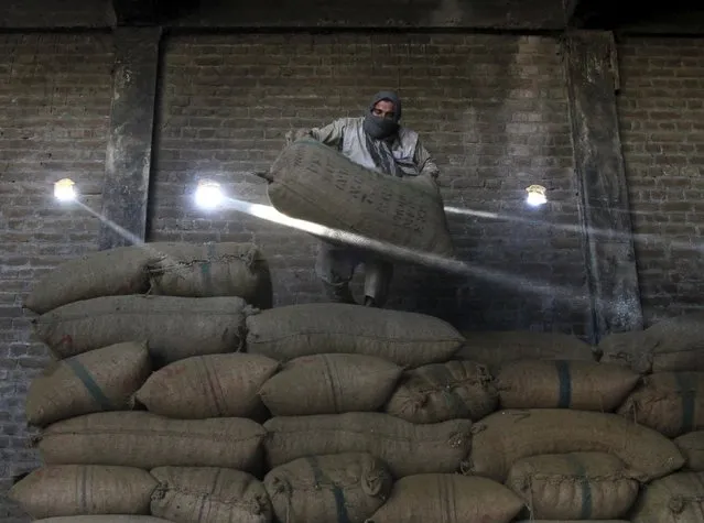 An Afghan man works at a dry fruit factory in Jalalabad, Afghanistan August 25, 2015. (Photo by Reuters/Parwiz)