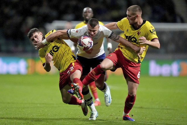 Preston North End's Milutin Osmajic, center, and Watford's Mattie Pollock, right, and James Morris battle for the ball during a Sky Bet Championship soccer match at Deepdale, Wednesday, October 2, 2024, in Preston, England. (Photo by Martin Rickett/PA Wire via AP Photo)