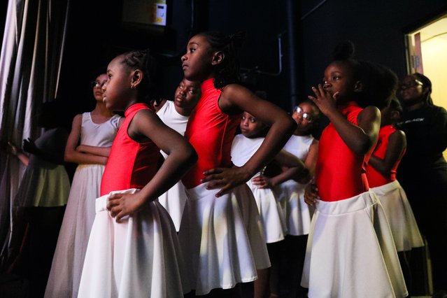 Ballerinas stand in the wings as they wait to perform on stage on October 26, 2024 in London, England. Pointe Black ballerinas celebrate the journey of the Windrush generation in a Afro-Carribean ballet style performance for Black History Month. Founded by Ruth Essel, Pointe Black is a Black owned ballet school based in south London. Fuelled by years of racial discrimination as a young Black ballerina, Ruth created Pointe Black to provide a safe space for Black children and adults to access ballet. (Photo by Alishia Abodunde/Getty Images)