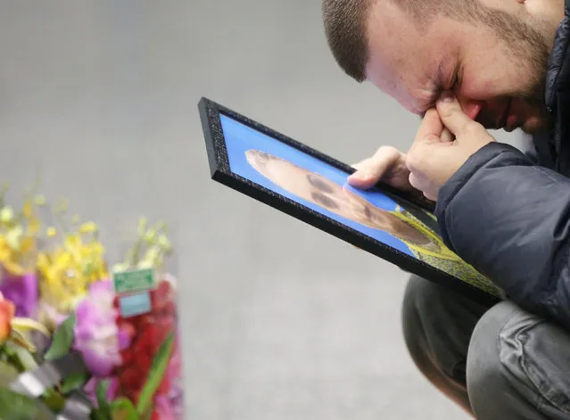 The partner of Julia Sologub, a member of the flight crew of the Ukrainian 737-800 plane that crashed on the outskirts of Tehran, reacts as he holds a portrait of her at a memorial inside Borispil international airport outside in Kyiv, Ukraine, Friday, January 10, 2020. Ukraine's president is calling on other countries to provide any information they have about the fatal crash of a Ukrainian airliner in Iran. President Volodymyr Zelenskiy's statement, reported Thursday on his office's Facebook page, came after U.S. officials said it was "highly likely" that the plane was downed by an Iranian anti-aircraft missile. (Photo by Efrem Lukatsky/AP Photo)