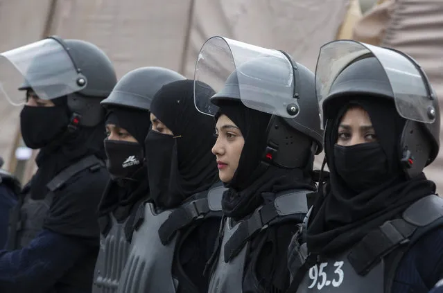 Pakistani police officers stand guard during a rally for International Women's Day in Islamabad, Pakistan, Sunday, March 8, 2020. Pakistanis held rallies across the country. Officially recognized by the United Nations in 1977, it is celebrated around the world on March 8. (Photo by B.K. Bangash/AP Photo)
