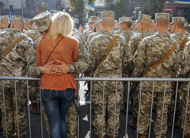 A Ukrainian serviceman hugs his girlfriend at Kiev's Independence Square, Ukraine, 24 August 2015, before a march on the occasion of Independence Day. Ukrainians marked the 24th anniversary of Ukraine's independence from the Soviet Union in 1991. (Photo by Roman Pilipey/EPA)