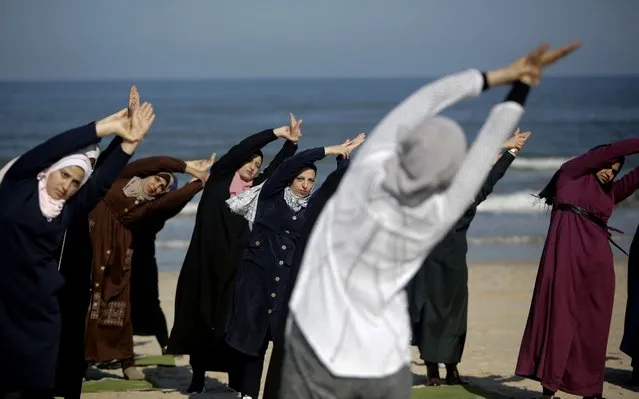 Palestinian women practise yoga on the beach in Gaza City on March 3, 2020 during an event organised by the the Positive Energy Club. (Photo by Mohammed Abed/AFP Photo)