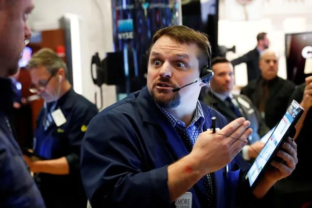 A trader reacts as he works on the floor of the New York Stock Exchange in New York, March 18, 2020. U.S. stocks deepened their selloff and the Dow erased virtually the last of its gains since President Donald Trump's 2017 inauguration, as the widening repercussions of the coronavirus pandemic threatened to cripple economic activity. (Photo by Lucas Jackson/Reuters)