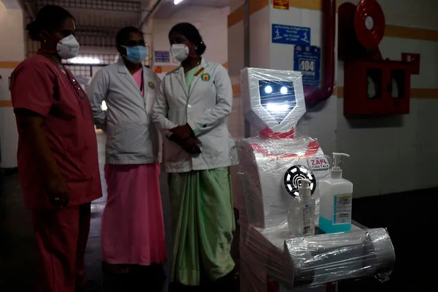 Medical staff participate in a demo of the interactive robot “Zafi” (R) which will be deployed at Covid -19 isolation wards, at Stanley Medical hospital in Chennai on April 6, 2020. (Photo by Arun Sankar/AFP Photo)