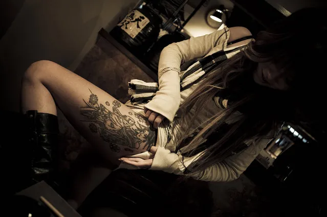 Young prostitute in a bar showing the tattoo on her leg – 2009. (Photo and caption by Anton Kusters)