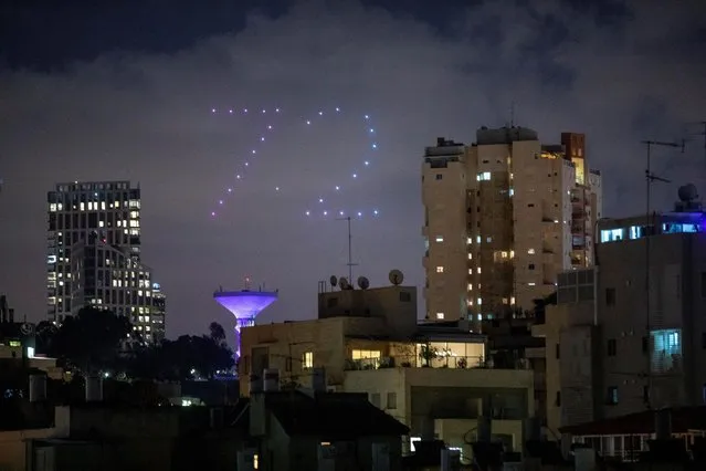 Drones form number 72 during celebrations for Israel's 72nd Independence Day, in Ramat Gan, Israel, Tuesday, April 28, 2020. Israel government announced a complete lockdown over the upcoming Israel's 72nd Independence Day to control the country's coronavirus outbreak. (Photo by Oded Balilty/AP Photo)