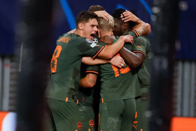 Shakhtar Donetsk's Burkinabe forward Lassina Traore (R) celebrates scoring the 1-4 goal with his team-mates during the UEFA Champions League Group F football match RB Leipzig v FC Shakhtar Donetsk in Leipzig, eastern Germany, on September 6, 2022. (Photo by Odd Andersen/AFP Photo)