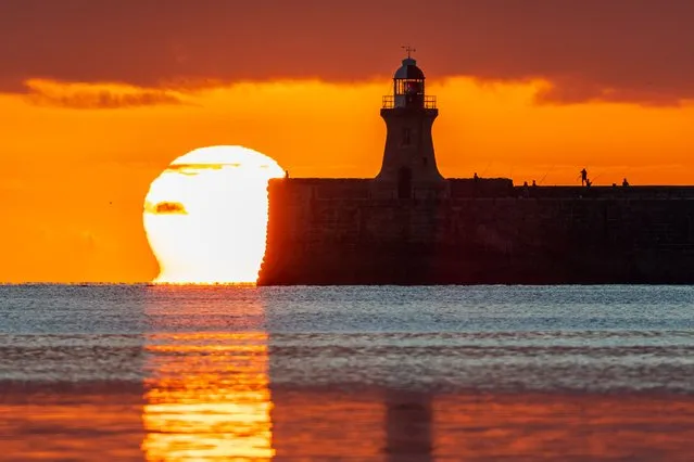 Fisherman are spotted on South Shields Pier, United Kingdom at sunrise on August 21, 2022. (Photo by John Fatkin/Cover Images)