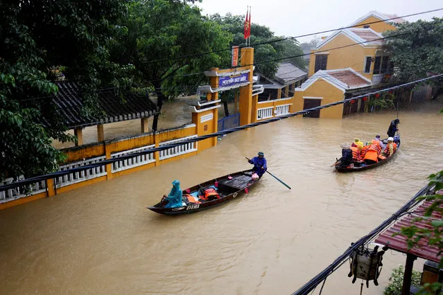People ride a boat along submerged houses in UNESCO heritage ancient town of Hoi An after typhoon Damrey hits Vietnam on November 6, 2017. (Photo by Reuters/Kham)