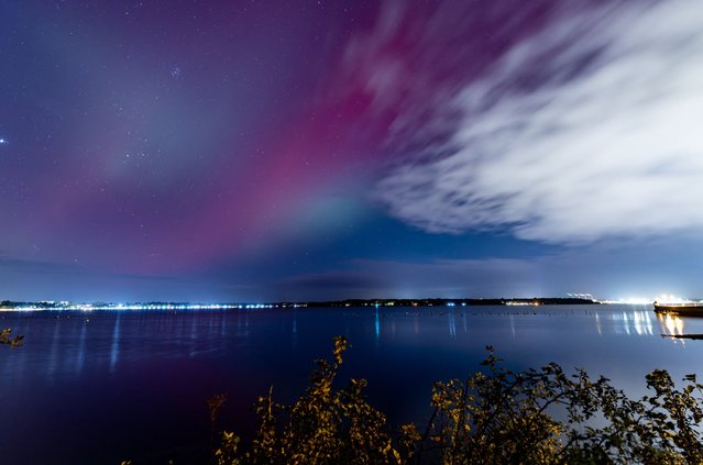 Northern lights (Aurora Borealis) are seen over the Baltic Sea close to Kiel, northern Germany, October 10, 2024. (Photo by AFP Photo/Stringer)