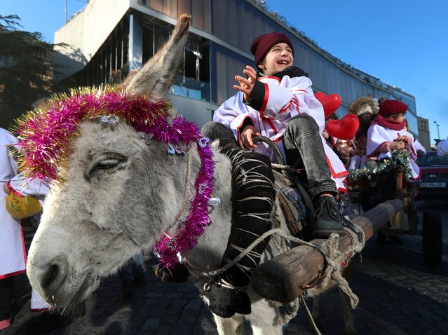 A boy rides a donkey during the traditional religious procession Alilo celebrating Orthodox Christmas in Tbilisi, Georgia on January 7, 2024. (Photo by Irakli Gedenidze/Reuters)