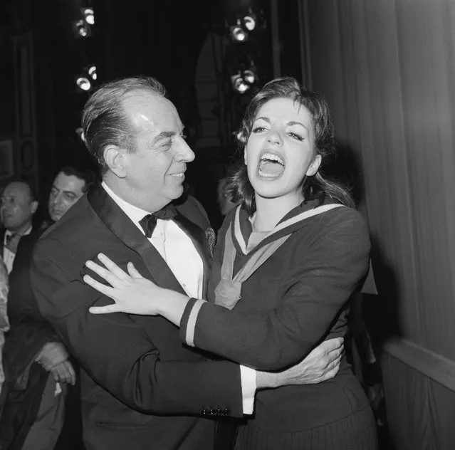 Thrilled with the excitement of opening night on Broadway, singer-actress Liza Minnelli shares the happy moment with her father Vincente Minnelli after the opening of Flora, the Red Menace, in which Miss Minnelli plays the title role in New York on May 13, 1965. The musical, directed by George Abbott and produced by Harold Prince, marks the Broadway debut of Liza, who is the daughter of Judy Garland. Opening night a the Alvin Theatre attracted a host of celebrities, including Senator Jacobs Javits and Representative John Lindsay. (Photo by Bettmann Archive via Getty Images)