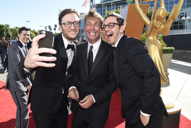 Akiva Schaffer, from left, Jack McBrayer and Jorma Taccone arrive at the 67th Primetime Emmy Awards on Sunday, September 20, 2015, at the Microsoft Theater in Los Angeles. (Photo by Dan Steinberg/Invision for the Television Academy/AP Images)