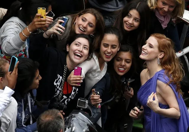 US actress Jessica Chastain (R) poses for photographs with fans as she arrives for the screening of “Foxcatcher” during the 67th annual Cannes Film Festival, in Cannes, France, 19 May 2014. (Photo by Guillaume Horcajuelo/EPA)