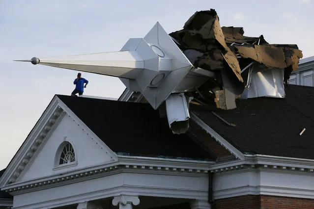 A person surveys the damage from the roof of College Church in Wheaton, Illinois after a severe storm toppled the church steeple on the campus of Wheaton College on August 10, 2020. (Photo by Mark Hume/Chicago Tribune/Tribune News Service via Getty Images)
