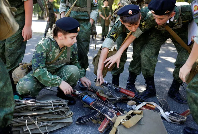 Fifth-grade students of the General Yermolov Cadet School get prepared before their first military tactical exercise on the ground, which includes radiation resistance classes, forest survival studies and other activities, in Stavropol, Russia, September 10, 2016. Picture taken September 10, 2016. (Photo by Eduard Korniyenko/Reuters)