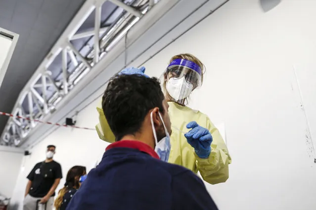 A passenger arriving in Rome from one four Mediterranean at Rome's Ciampino airport is tested for COVID-19, Tuesday, August18, 2020. Italy's health minister issued an ordinance requiring the tests for all travelers arriving in Italy from Croatia, Greece, Malta or Spain. (Photo by Cecilia Fabiano/LaPresse via AP Photo)