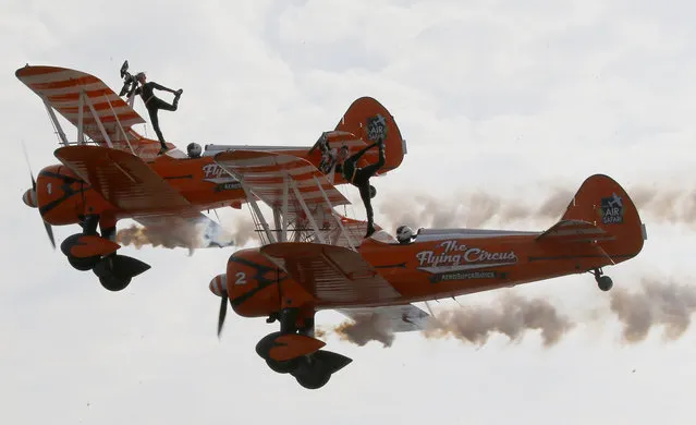 British female members of the Aerosuperbatics Wingwalkers, perform aerobatic stunts for the first time in the Philippines during the four-day 22nd International Hot Air Balloon festival at Clark, Pampanga province north of Manila, Philippines, Thursday, February 8, 2018. The festival showcases 26 colorful hot air balloons in various shapes and sizes from different countries such as Japan, United States, Malaysia, Germany, Great Britain, Turkey, Canada, South Korea and is considered the longest-running sports aviation event in Asia. (Photo by Bullit Marquez/AP Photo)