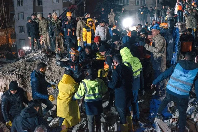 Rescue workers and Turkish army soldiers carry a woman they found alive under the rubble over 18 hours after the building collapsed in Sanliurfa, Turkey on February 6, 2023. (Photo by Alice Martins/For The Washington Post)