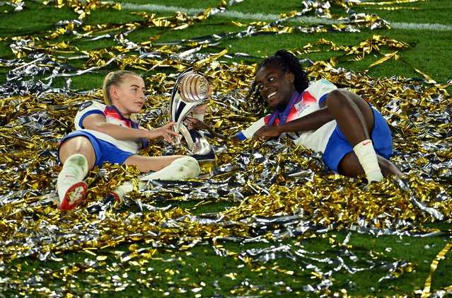 Chloe Kelly and Michelle Agyemang of England celebrate with the UEFA Women's EURO trophy while laying in ticker tape after their team's victory in the UEFA Women's EURO 2025 Final match between England and Spain at St. Jakob-Park on July 27, 2025 in Basel, Switzerland. (Photo by Matthias Hangst/Getty Images)