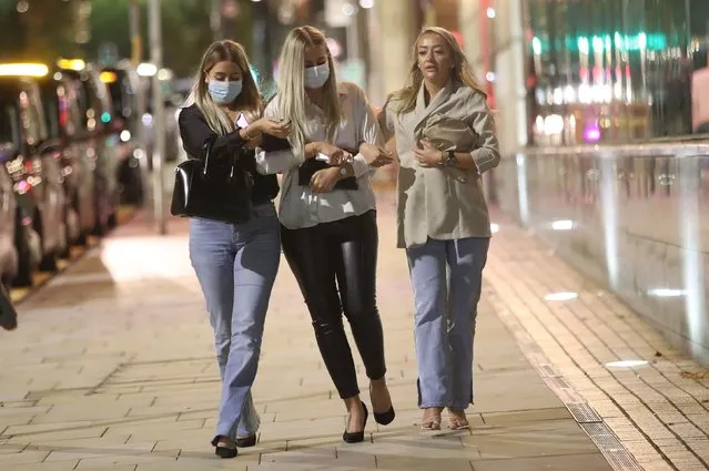 Three women out for the evening in Manchester on October 11, 2020, ahead of a possible government announcement on Monday. Cities in northern England and other areas suffering a surge in Covid-19 cases may have pubs and restaurants temporarily closed to combat the spread of the virus. (Photo by Danny Lawson/PA Images via Getty Images)