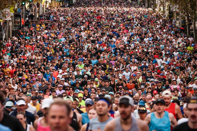 Participants run at the start of the annual City to Surf fun run in central Sydney on August 10, 2025. (Photo by David Gray/AFP Photo)