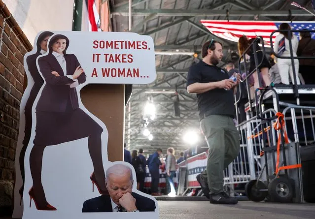 A man walks past a cut-out that depicts former U.S. Ambassador to the United Nations Nikki Haley and U.S President Joe Biden as she announces her run for the 2024 Republican presidential nomination at a campaign event in Charleston, South Carolina, U.S. February 15, 2023. (Photo by Jonathan Ernst/Reuters)