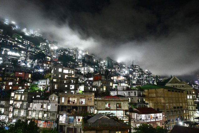 Clouds loom over the night sky in Aizawl, capital of India's north-eastern state of Mizoram on September 17, 2025. (Photo by Biju Boro/AFP Photo)
