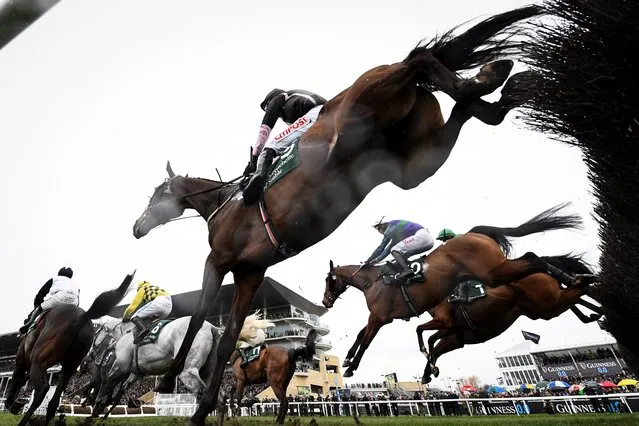 Competitors take part in The Brown Advisory Novices’ Steeple on the second day of the Cheltenham Festival at Cheltenham Racecourse, in Cheltenham, western England on March 15, 2023. (Photo by Glyn Kirk/AFP Phoot)