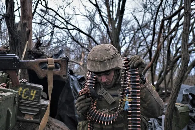 A soldier of the Ukrainian Volunteer Army prepares ammunition to fire at Russian front line positions near Bakhmut, Donetsk region, on March 11, 2023, amid the Russian invasion of Ukraine. (Photo by Sergey Shestak/AFP Photo)