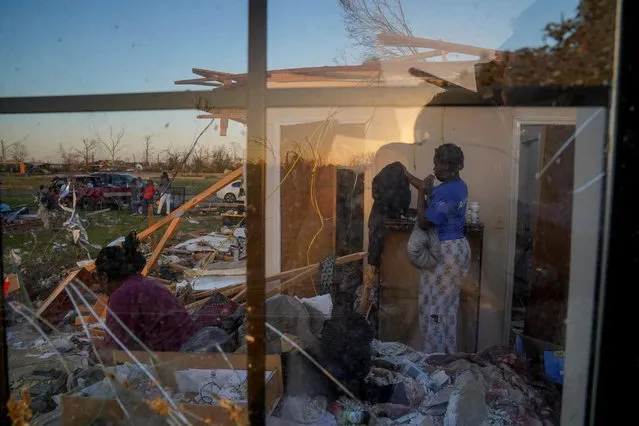 Shirley Stamps, 58, (left) sits on her bed as her granddaughter Jakhia, 16, (right) sorts through belongings in the wreckage of Shirley?s home after thunderstorms spawning high straight-line winds and tornadoes ripped across the state in Rolling Fork, Mississippi, U.S., March 25, 2023. (Photo by Cheney Orr/Reuters)