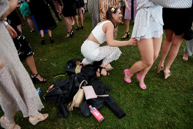 A Race goer falls over the handbags she was dancing around after the Geelong Cup on Geelong Cup day at Geelong Racecourse in Melbourne, Wednesday, October 19, 2016. (Photo by Tracey Nearmy/AAP Image)