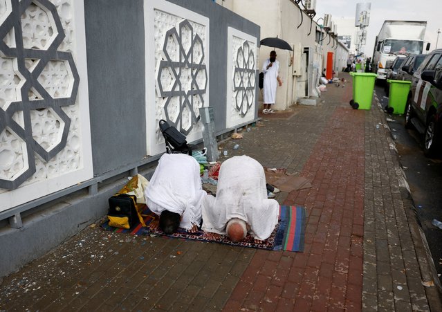 Pilgrims pray during rainfall, on the second day of the Satan stoning ritual, during the annual haj pilgrimage, in Mina, Saudi Arabia on June 17, 2024. (Photo by Mohammed Torokman/Reuters)