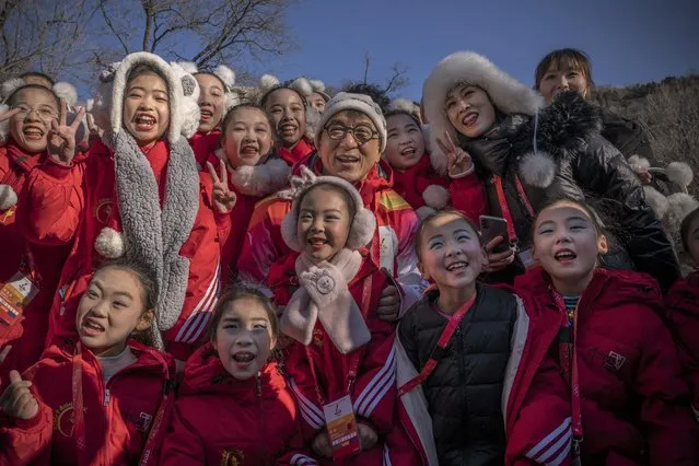 Actor Jackie Chan poses for photos with children at the end of the Beijing 2022 Winter Olympics Torch Relay on the Great Wall of China on February 03, 2022 in Beijing, China. (Photo by Andrea Verdelli/Getty Images)