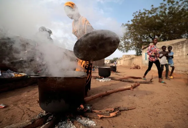 Women prepare an Iftar meal to distribute during the holy month of Ramadan in Notto Gouye Diama village, Thies region, Senegal on April 11, 2023. (Photo by Zohra Bensemra/Reuters)