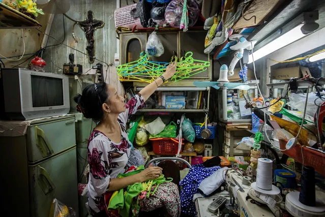 Nguyen Thi Kim Ngoc arranges cloth- hangers in her 6.7- square- metre home in Ho Chi Minh City on May 3, 2018. (Photo by Thanh Nguyen/AFP Photo)