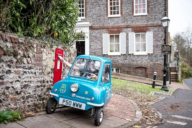 Alex Orchin, 31 years old and 5ft 11in tall, posts a letter in his village of Wivelsfield in East Sussex on March 29, 2022 from the confines of his Peel P50, the world’s smallest car at 4ft long, 3ft wide and a smidgen over 3ft high. (Photo by James Linsell-Clark/South West News Service)