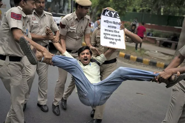 Student activists who had come to support of protesting wrestlers are detained by the police as they try to join them in a march towards the newly inaugurated parliament, in New Delhi, India, Sunday, May, 28, 2023. India's top wrestlers have been protesting for more than a month, demanding the resignation and arrest of the president of the wrestling federation for allegedly sexually harassing young athletes. (Photo by Altaf Qadri/AP Photo)