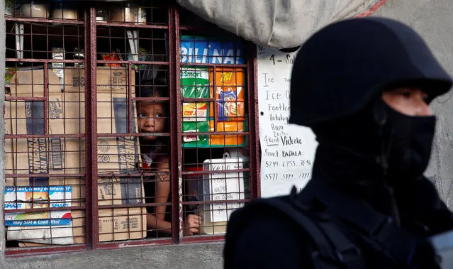 A girl looks out from the window during an anti-drug operation by the police, in Pasig, Metro Manila in the Philippines, November 9, 2016. (Photo by Erik De Castro/Reuters)