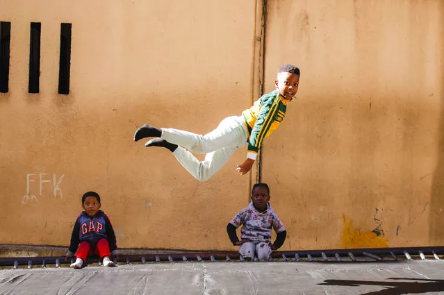 A young boy enjoys the morning fun on one of the three public trampolines in the Alexandra township in Johannesburg, South Africa on June 16, 2023. The children jump after school each day as one of the rare extra activities in one of Johannesburg oldest and most impoverished townships. Life in the township has been even harsher lately with crime rates increasing, unemployment on the rise and load shedding effecting the small businesses that are part of the macro economic environment. South Africa is marking Youth Day today as the country takes a public holiday. (Photo by Kim Ludbrook/EPA/EFE)