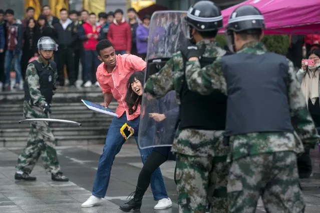 Police and civilians take part in an anti-terrorism drill at a college in Hangzhou, Zhejiang province, China December 10, 2015. (Photo by Reuters/Stringer)