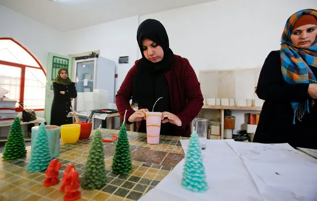 A Palestinian woman uses wax to make decorative objects in the West Bank town of Dura, south of Hebron November 17, 2016. (Photo by Mussa Qawasma/Reuters)