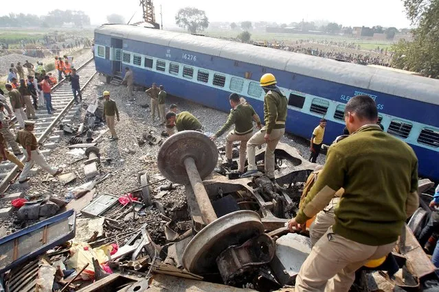 Rescue workers search for survivors at the site of a train derailment in Pukhrayan, south of Kanpur city, India November 20, 2016. (Photo by Jitendra Prakash/Reuters)