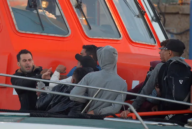 Migrants, intercepted aboard dinghies off the coast in the Strait of Gibraltar, argue on a rescue boat upon arrival at dawn at the port of Barbate, southern Spain, July 28, 2018. (Photo by Jon Nazca/Reuters)