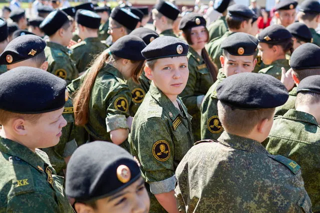 Students attend a ceremony for school graduates celebrating the end of the academic year at General Yermolov Cadet Secondary School in Stavropol, Russia on May 25, 2022. In cadet secondary schools, the curriculum includes elements of military training and promotes patriotism. The traditional ceremony known as “the Last Bell” takes place before secondary school graduates take their final exams. In 2022, Russia's Ministry of Education recommended that Russian schools hold end-of-school ceremonies in person; in 2020 and 2021, these ceremonies were held online due to the COVID-19 pandemic. (Photo by Ivan Vysochinsky/TASS)