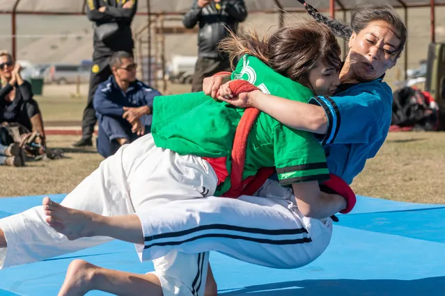 Meerim Momunova wrestles with her fellow Kyrgyz teammate Anara Ryskulova during a performance of a traditional style of wrestling called “Alysh”. Momunova is a champion in Asia and has been competing since 2015, after a background in judo. According to Momunova, one of the advantages of “Alysh” is the ease of the uniform for women – even Muslim women who cover their faces can compete. Momunova holds a degree in sports coaching and hopes to see more women come into this sport. (Photo by Eleanor Moseman/The Guardian)