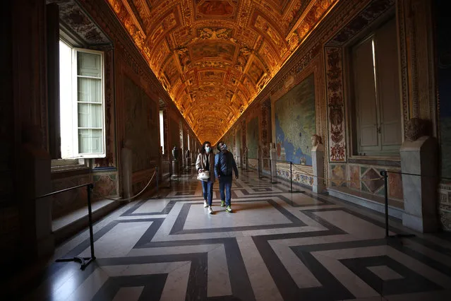 Visitors wearing masks to prevent the spread of coronavirus walks inside the Vatican Museum after it reopened, in Rome, Monday, May 3, 2021. The Vatican Museums reopened Monday to visitors after a shutdown following COVID-19 containment measures. (Photo by Alessandra Tarantino/AP Photo)