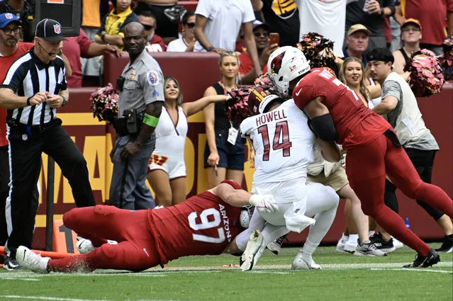 Arizona Cardinals linebacker Kyzir White (7) gets called for a penalty after hitting Washington Commanders quarterback Sam Howell (14) with his helmet during the first quarter of the game at FedEx field on September 10, 2023. (Photo by Jonathan Newton/The Washington Post)