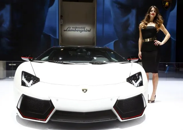 A model poses next to a Lamborghini Aventador LP 700-4 during the second press day ahead of the 85th International Motor Show in Geneva March 4, 2015.  REUTERS/Arnd Wiegmann   